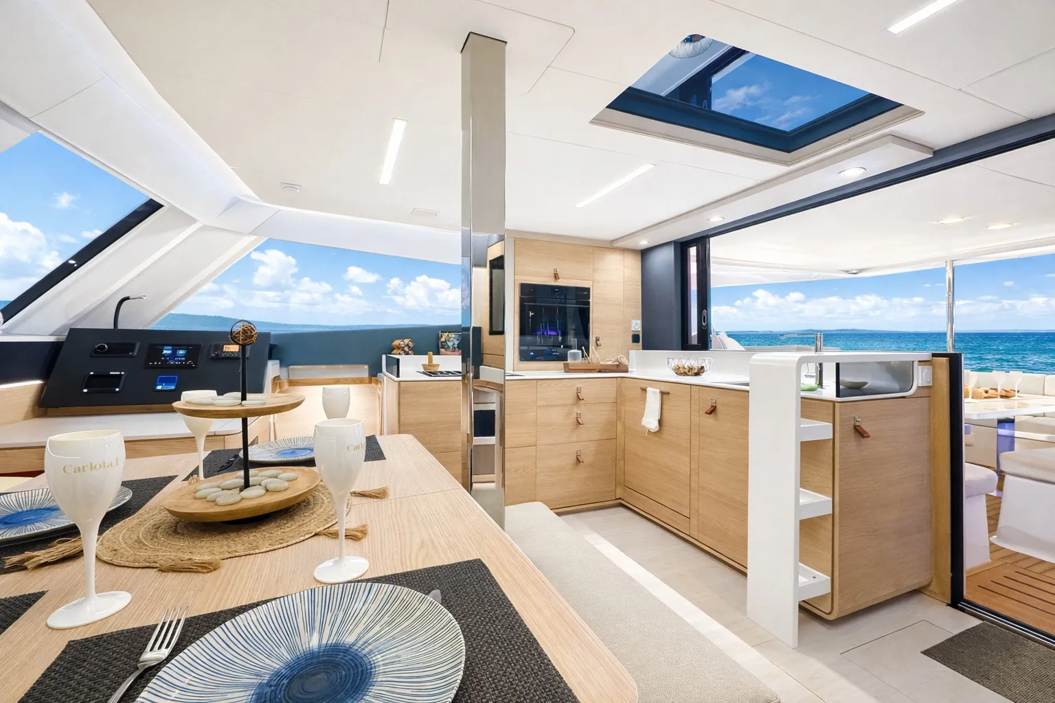 The saloon, with a light oak galley and windows on three sides
